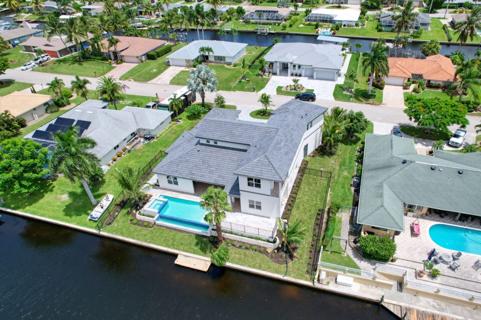 A bird 's eye view of houses and pool.